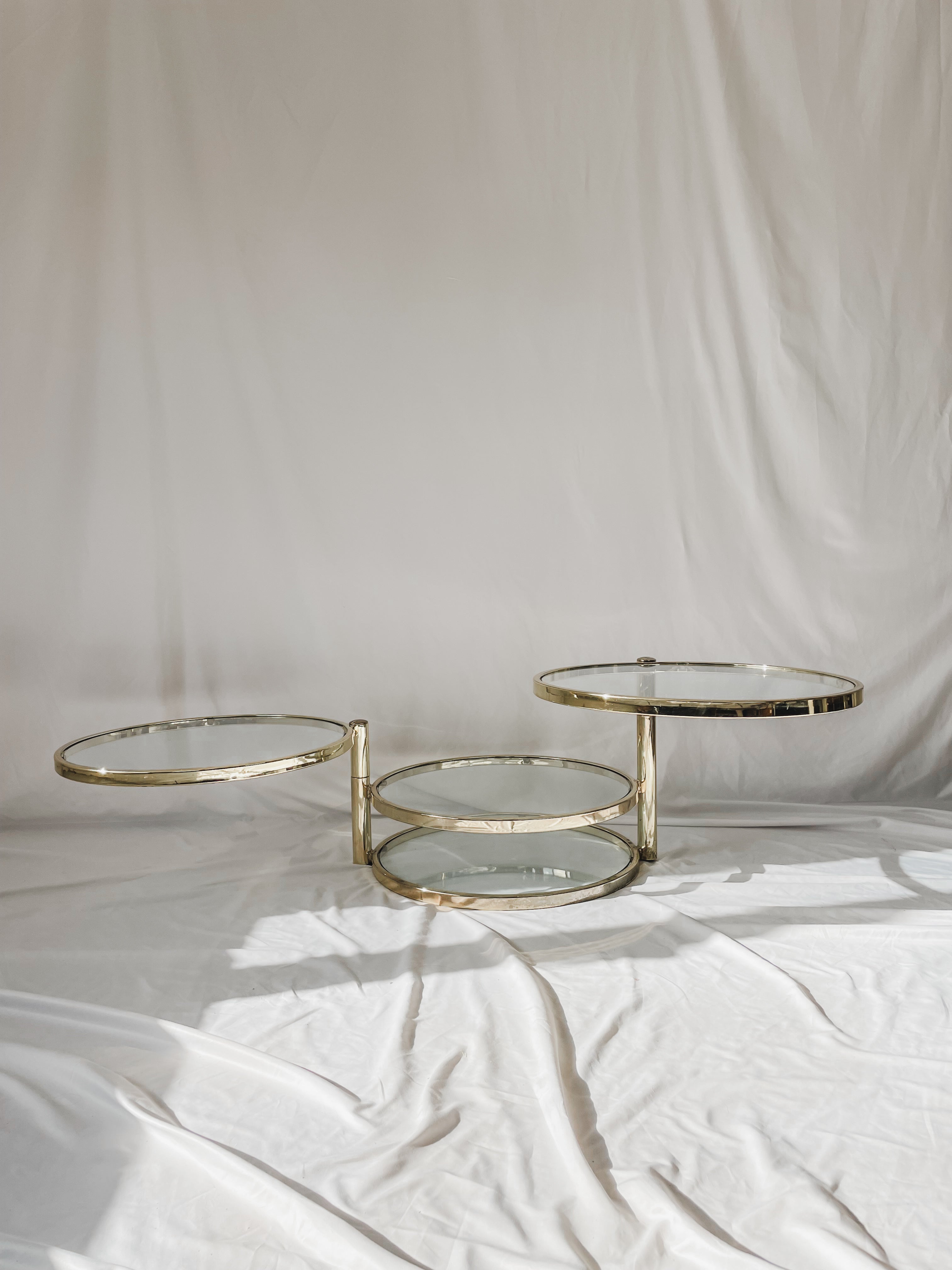 VINTAGE BRASS AND GLASS 4 TIER SWIVEL TABLE