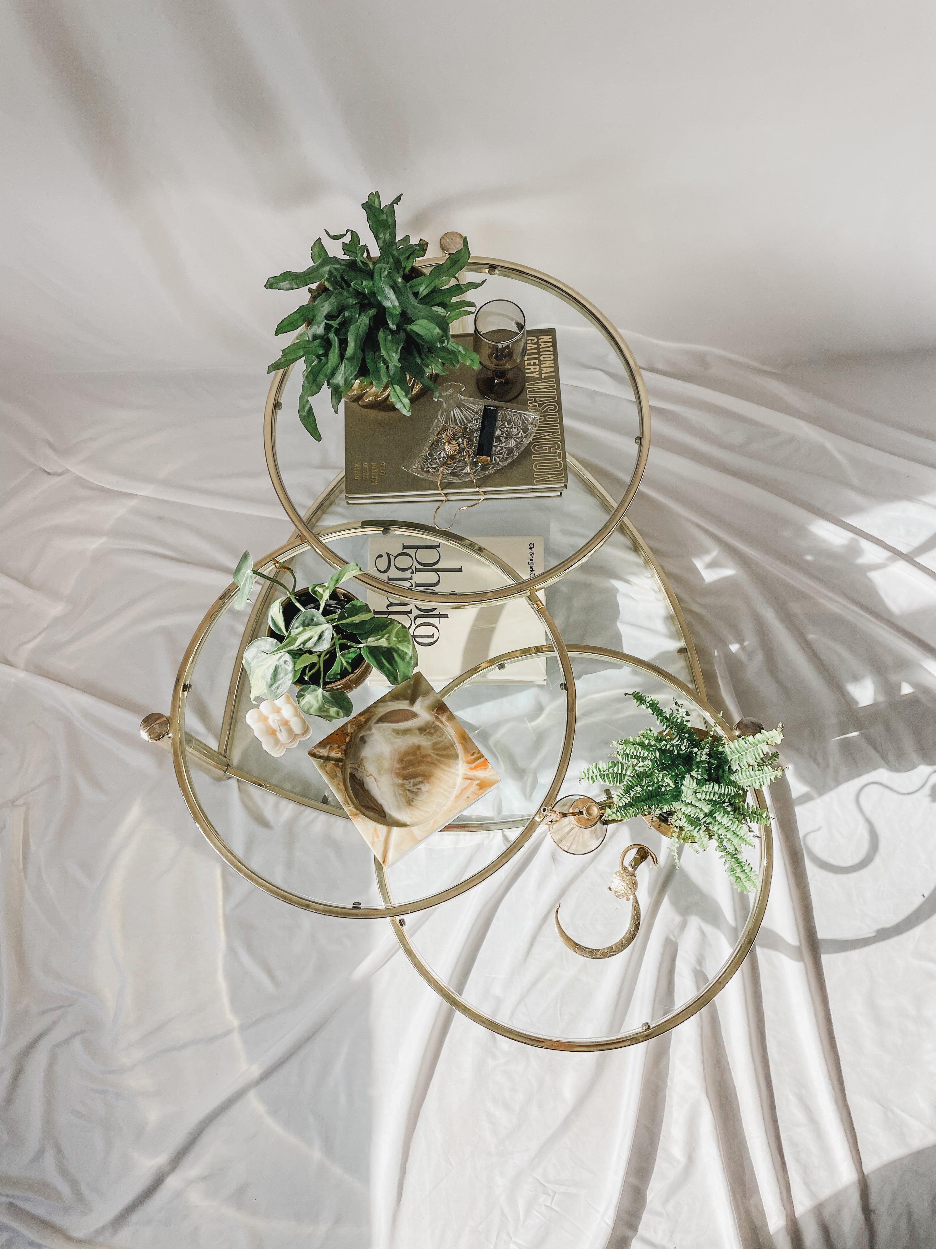 VINTAGE BRASS AND GLASS 4 TIER SWIVEL COFFEE TABLE