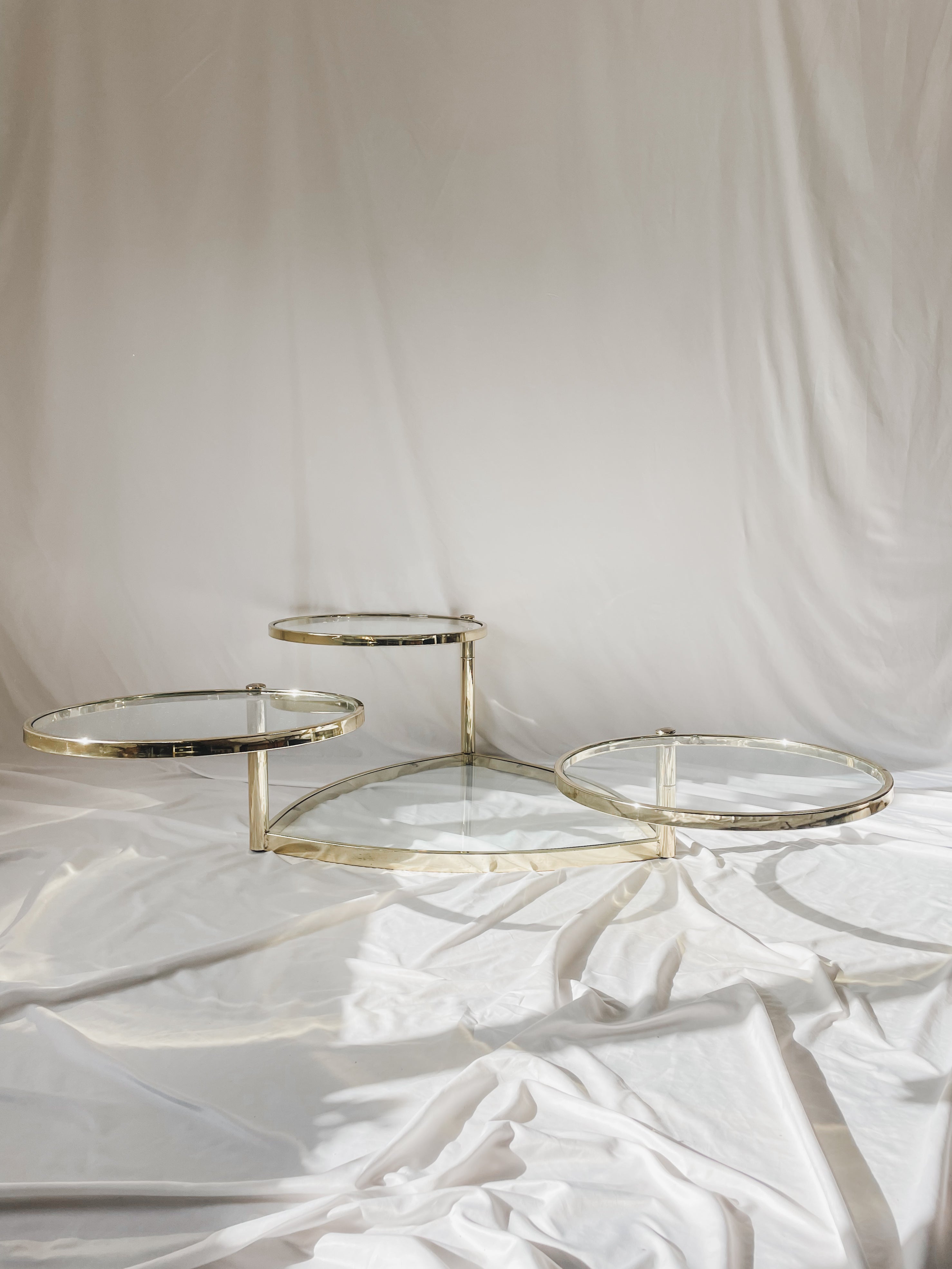 VINTAGE BRASS AND GLASS 4 TIER SWIVEL COFFEE TABLE