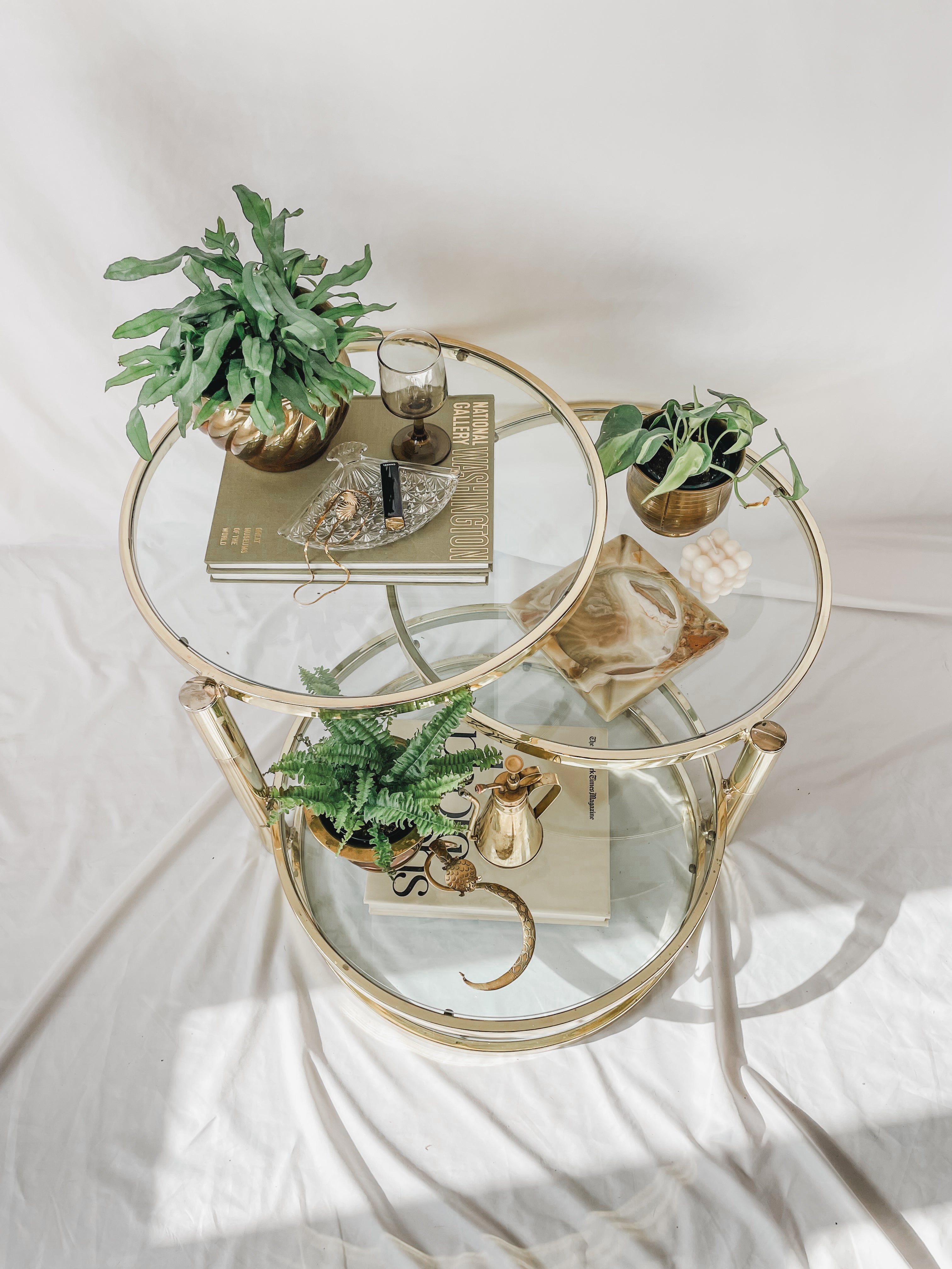 VINTAGE BRASS AND GLASS 4 TIER SWIVEL TABLE