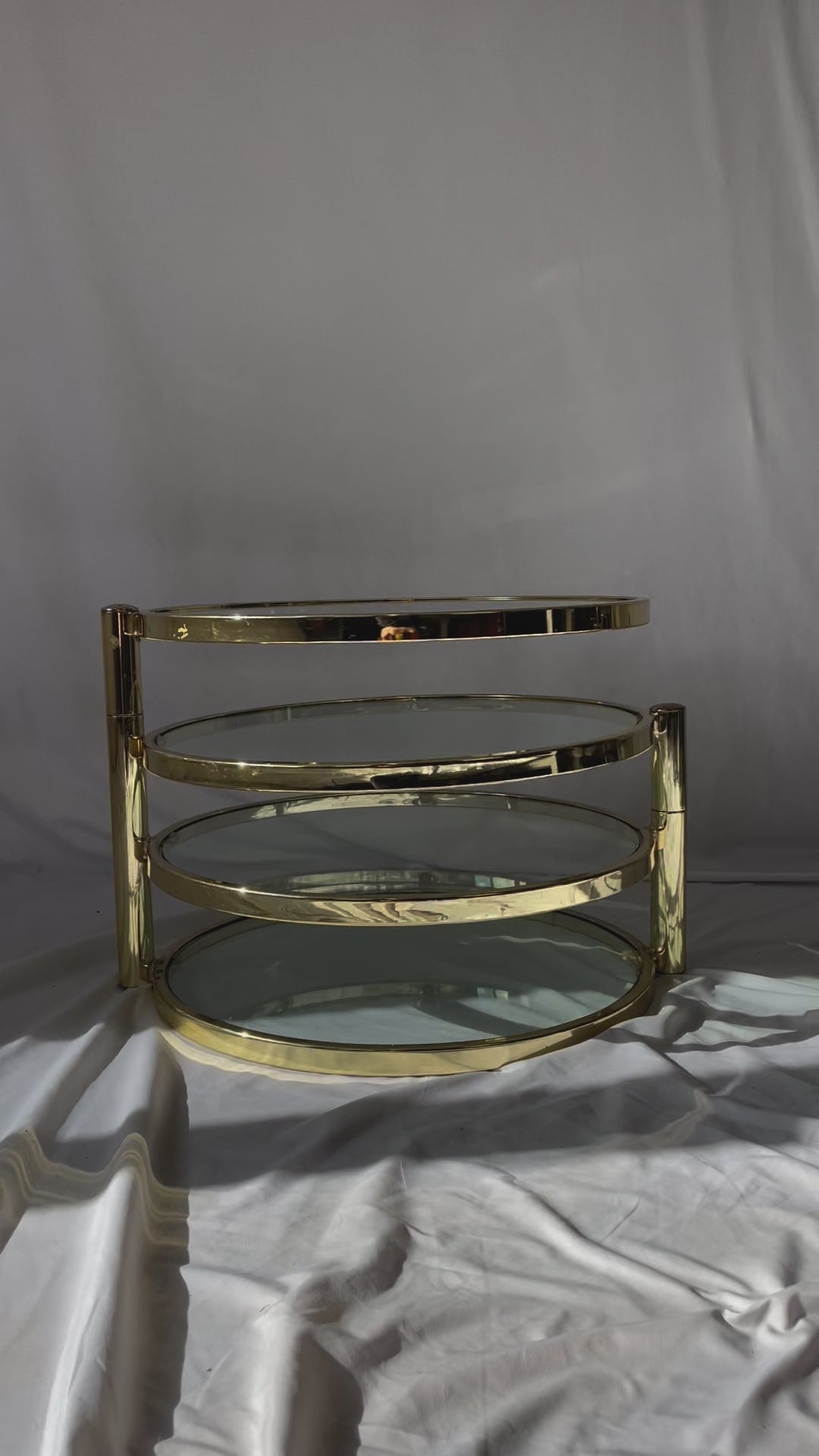 VINTAGE BRASS AND GLASS 4 TIER SWIVEL TABLE