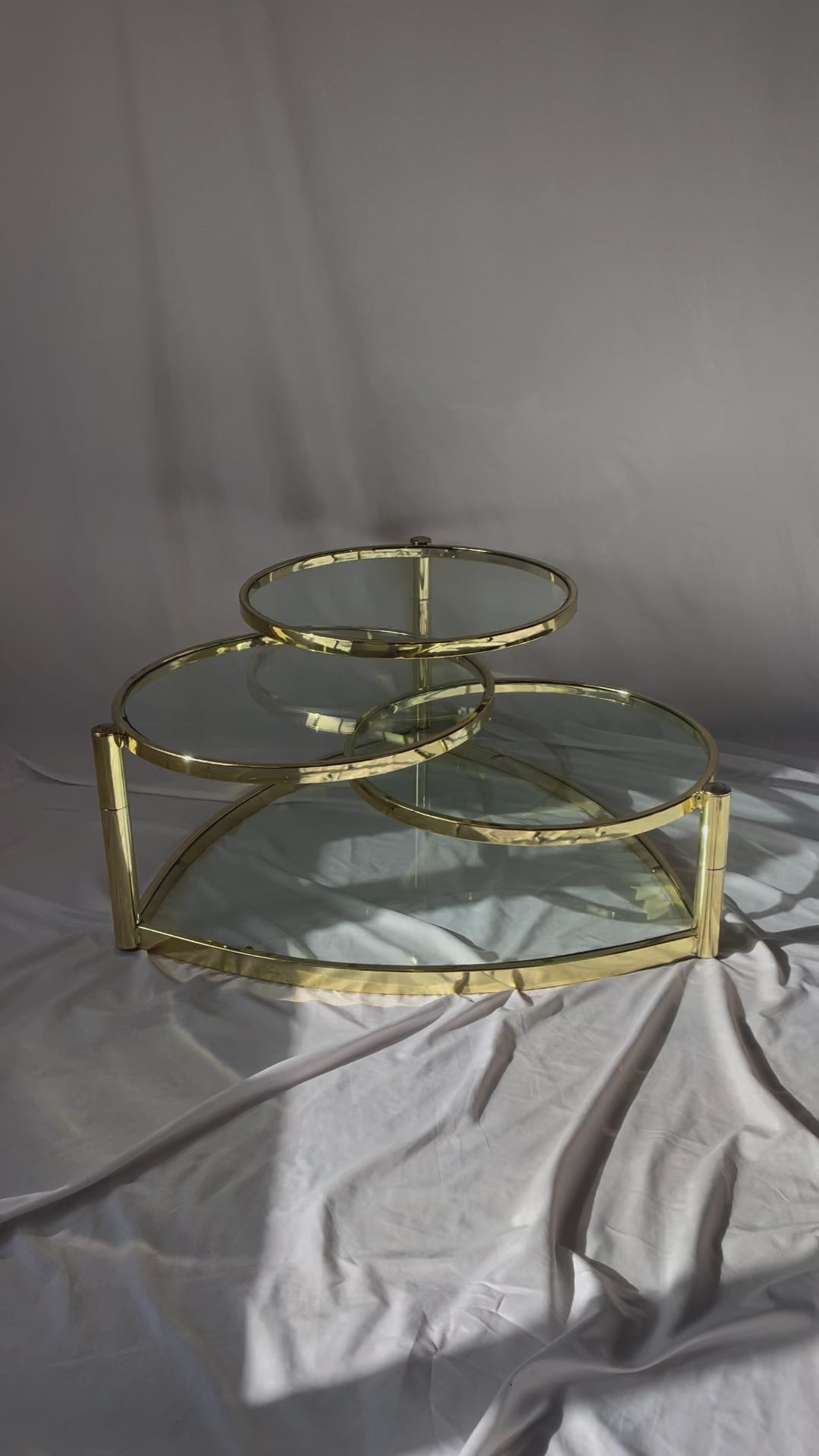 VINTAGE BRASS AND GLASS 4 TIER SWIVEL COFFEE TABLE