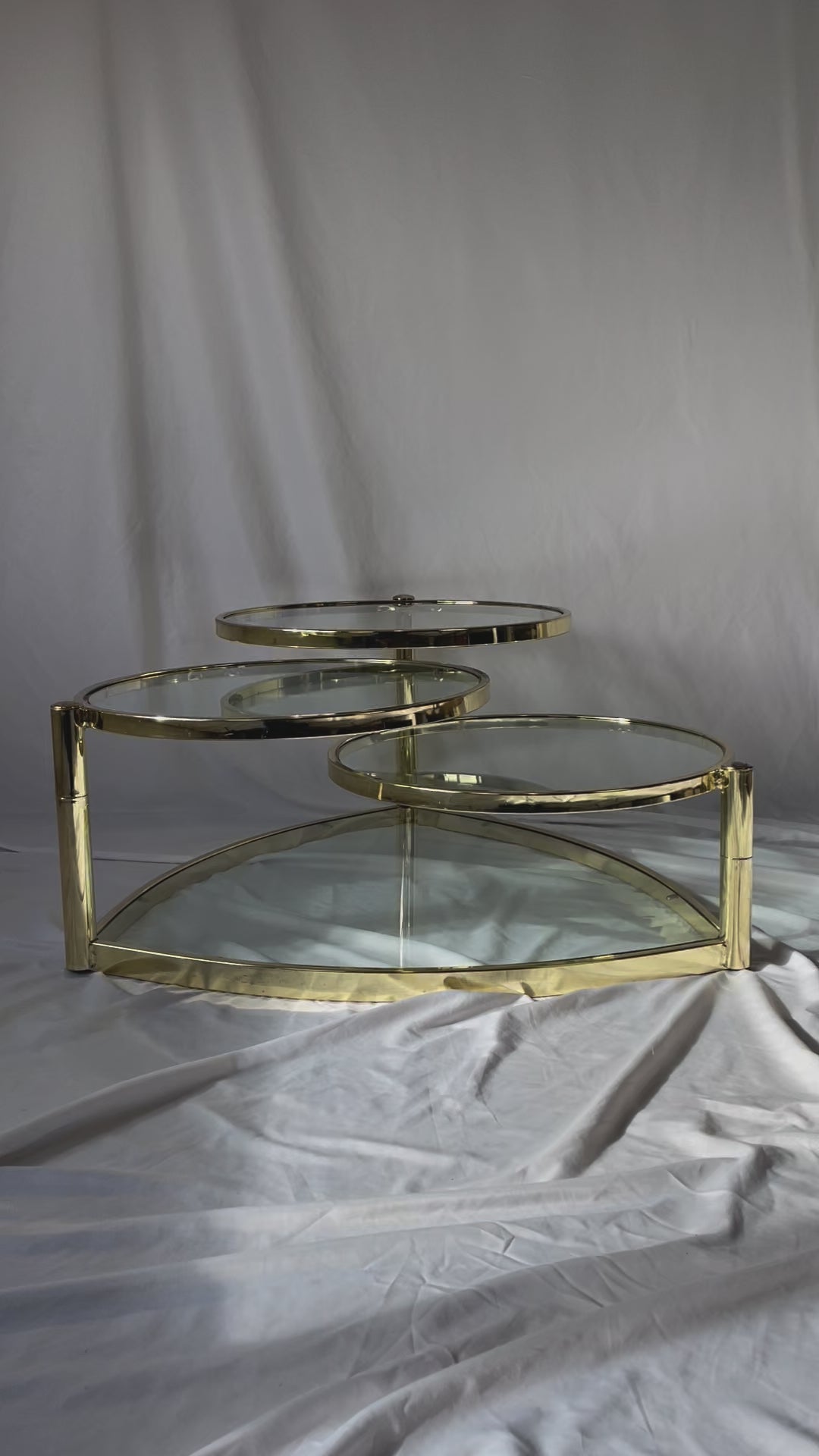 VINTAGE BRASS AND GLASS 4 TIER SWIVEL COFFEE TABLE