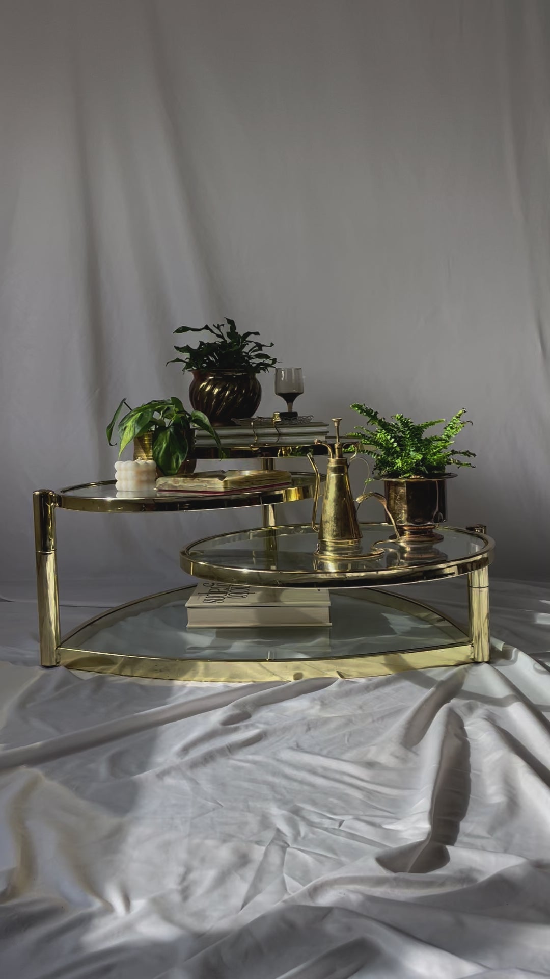 VINTAGE BRASS AND GLASS 4 TIER SWIVEL COFFEE TABLE