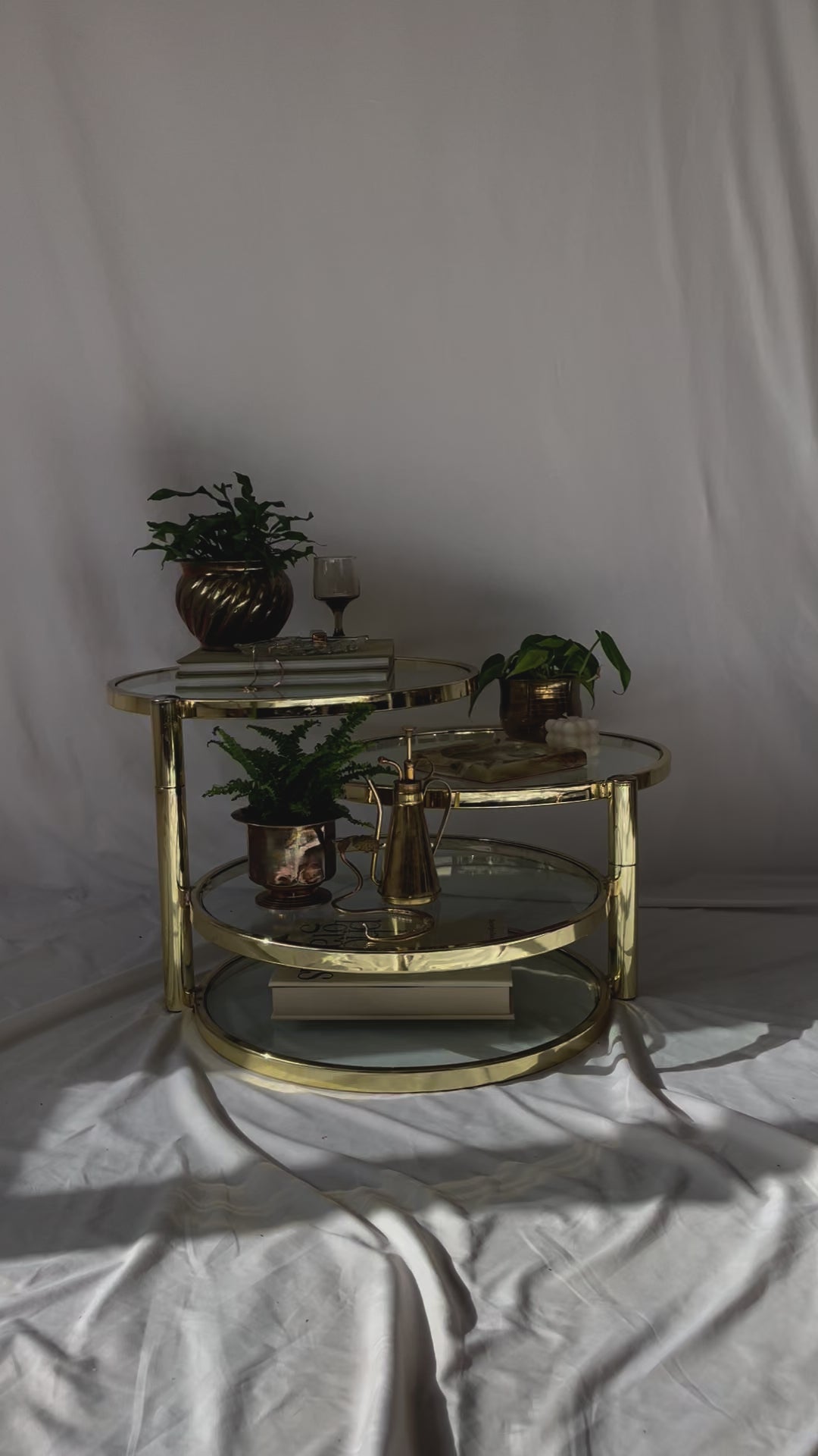 VINTAGE BRASS AND GLASS 4 TIER SWIVEL TABLE